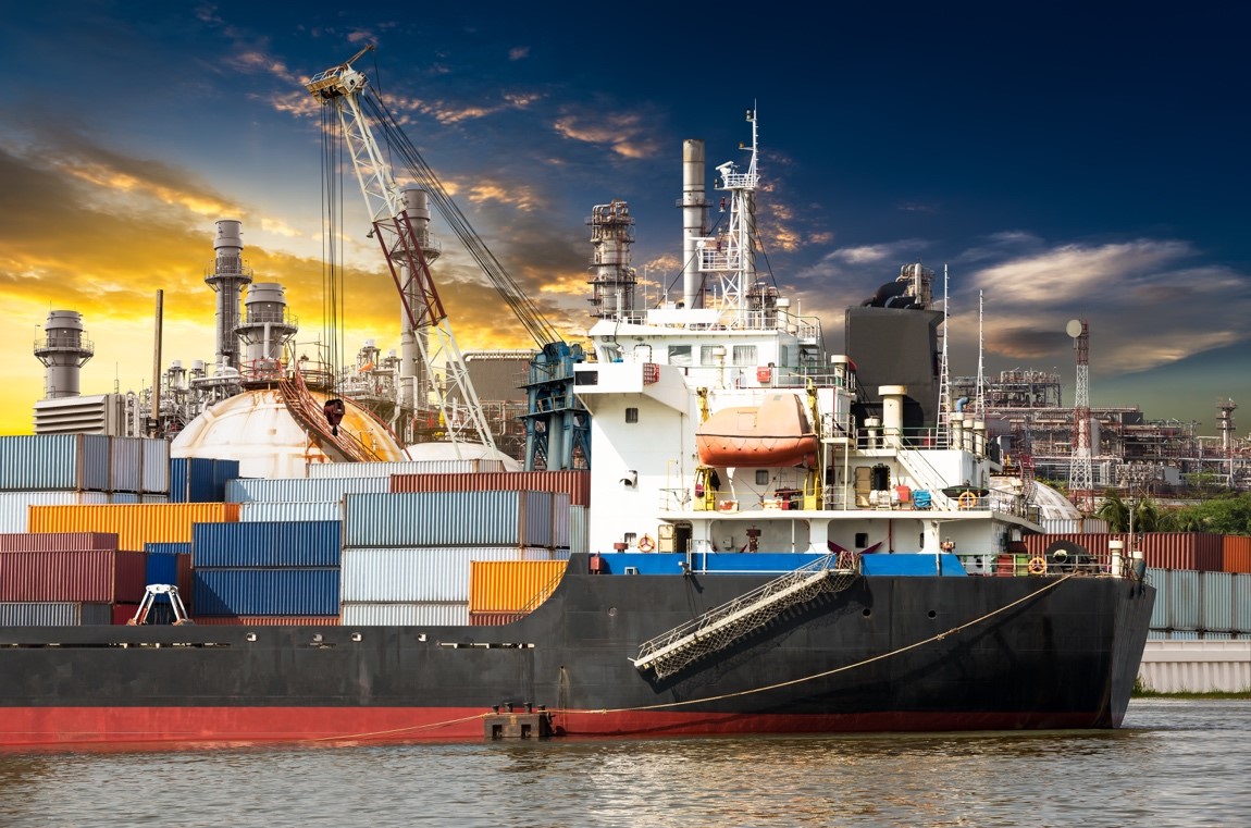 Container stack in ocean ship at shipping port with sunset background